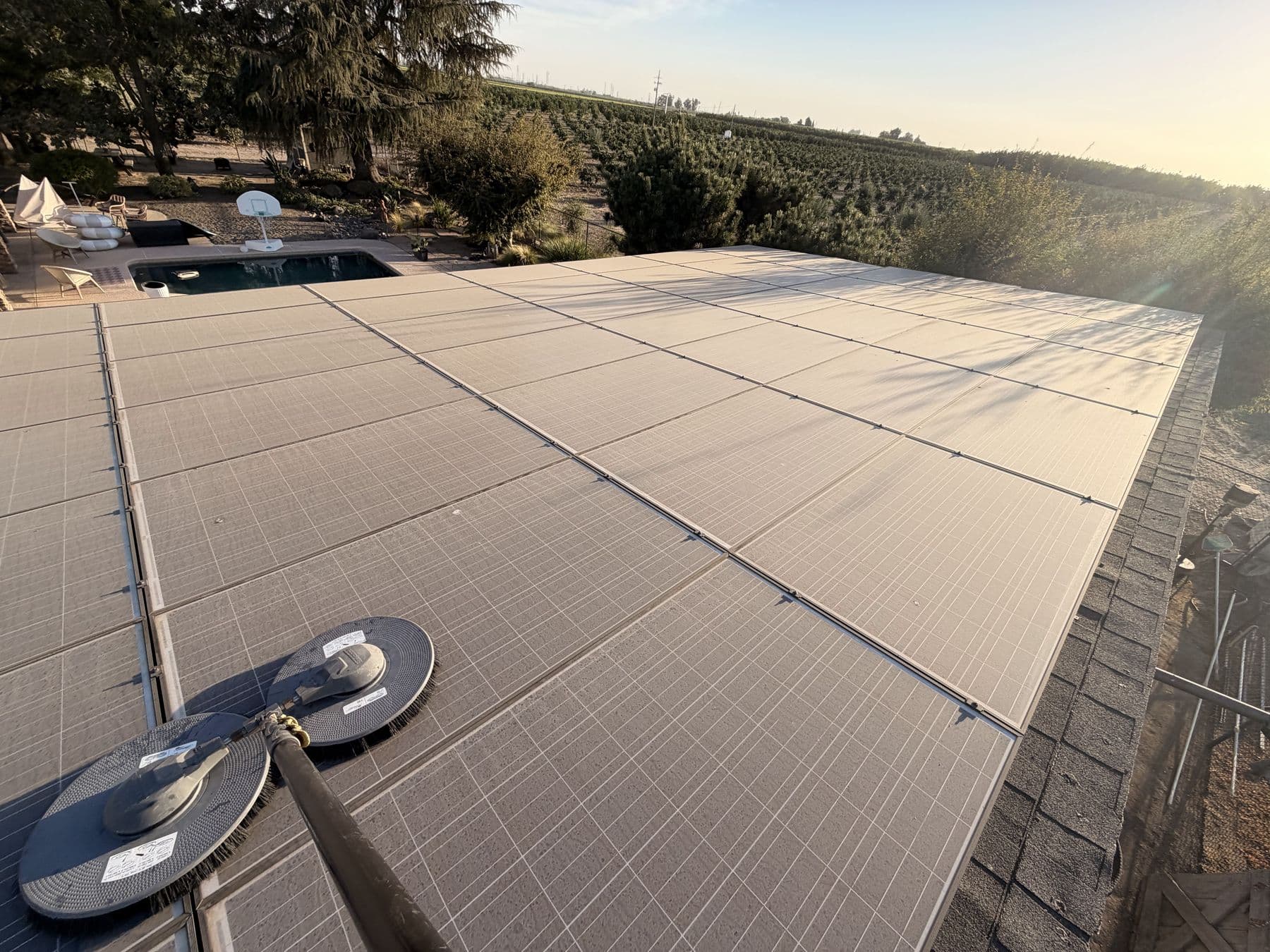Rotary brush cleaning a large rooftop solar array