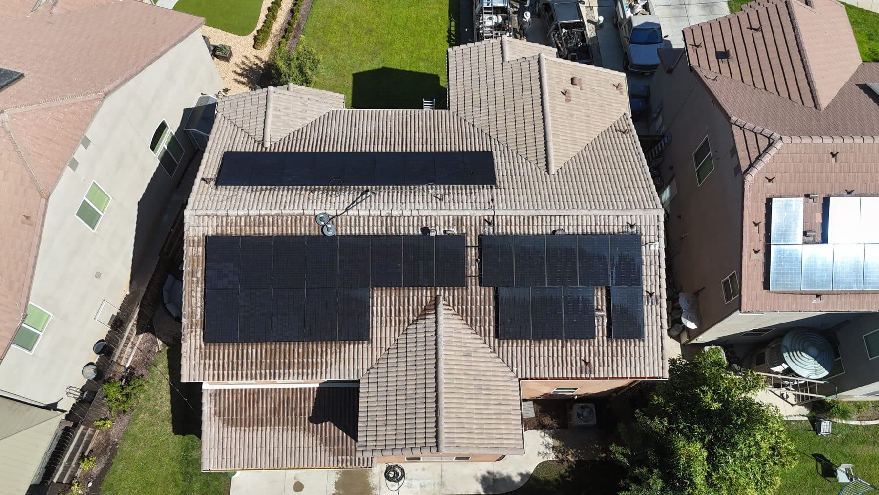 Overhead drone view of freshly cleaned solar panels on a tile roof